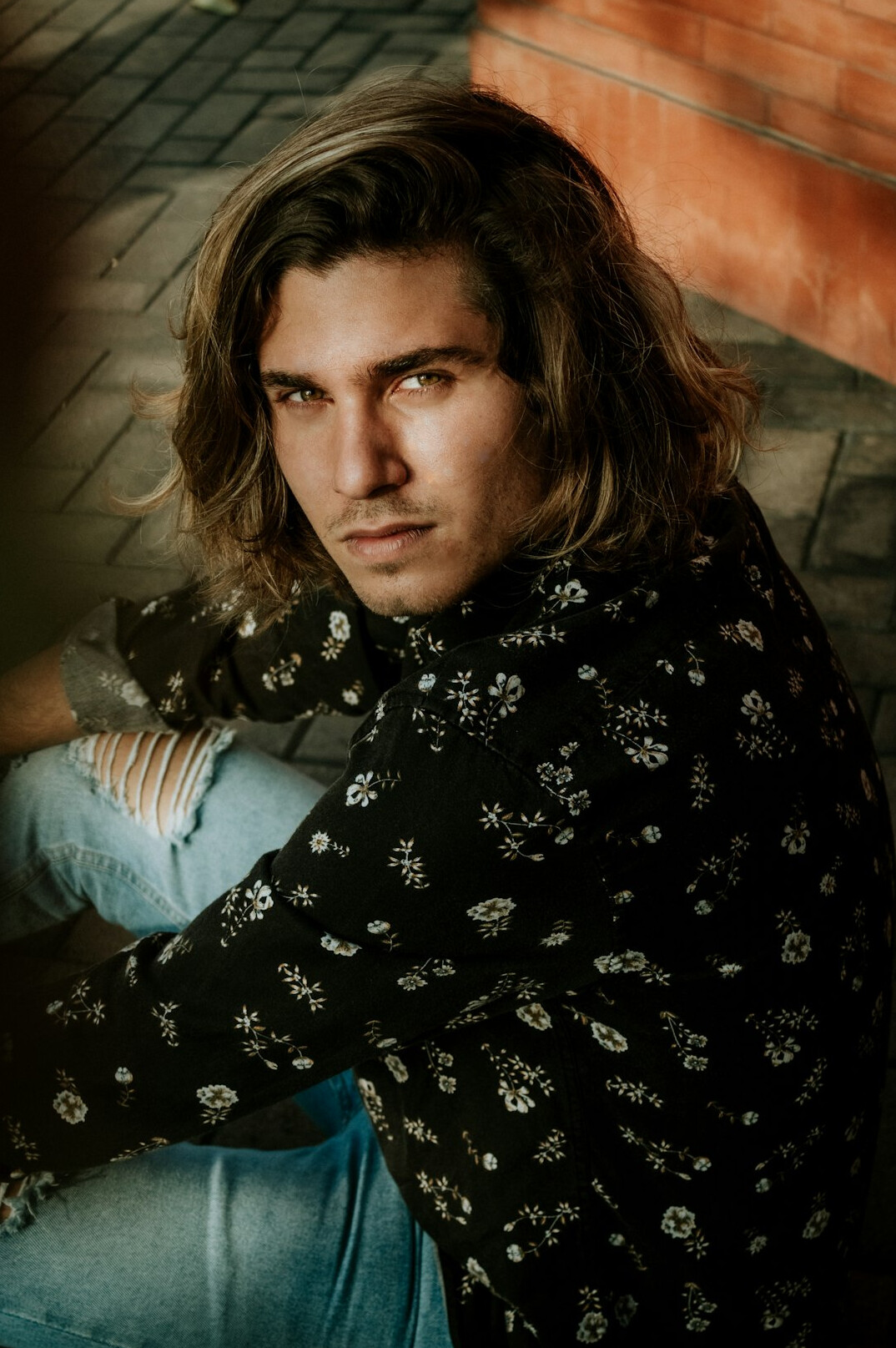 Portrait of a man with dark hair in a casual shirt