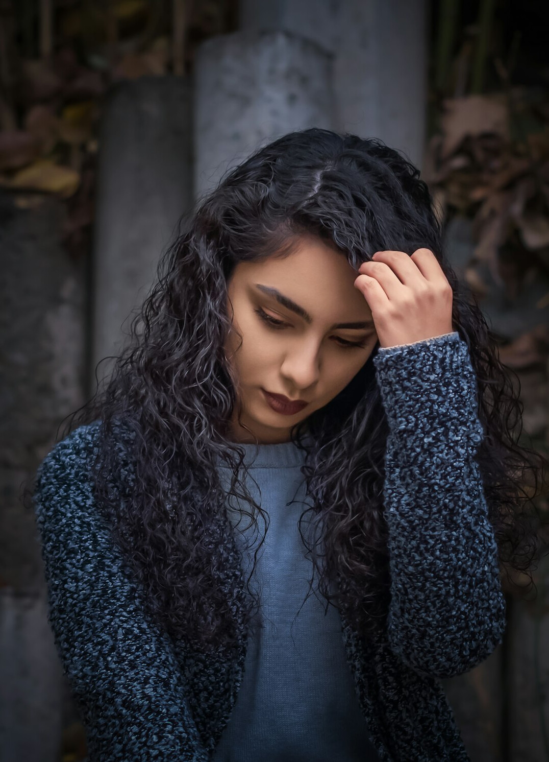 Portrait of a young woman with dark curly hair
